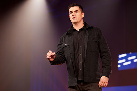 photo of Dr. John Delony speaking at an event